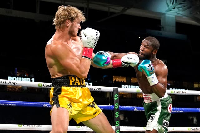 Logan Paul, left, and Floyd Mayweather fight during an exhibition boxing match at Hard Rock Stadium