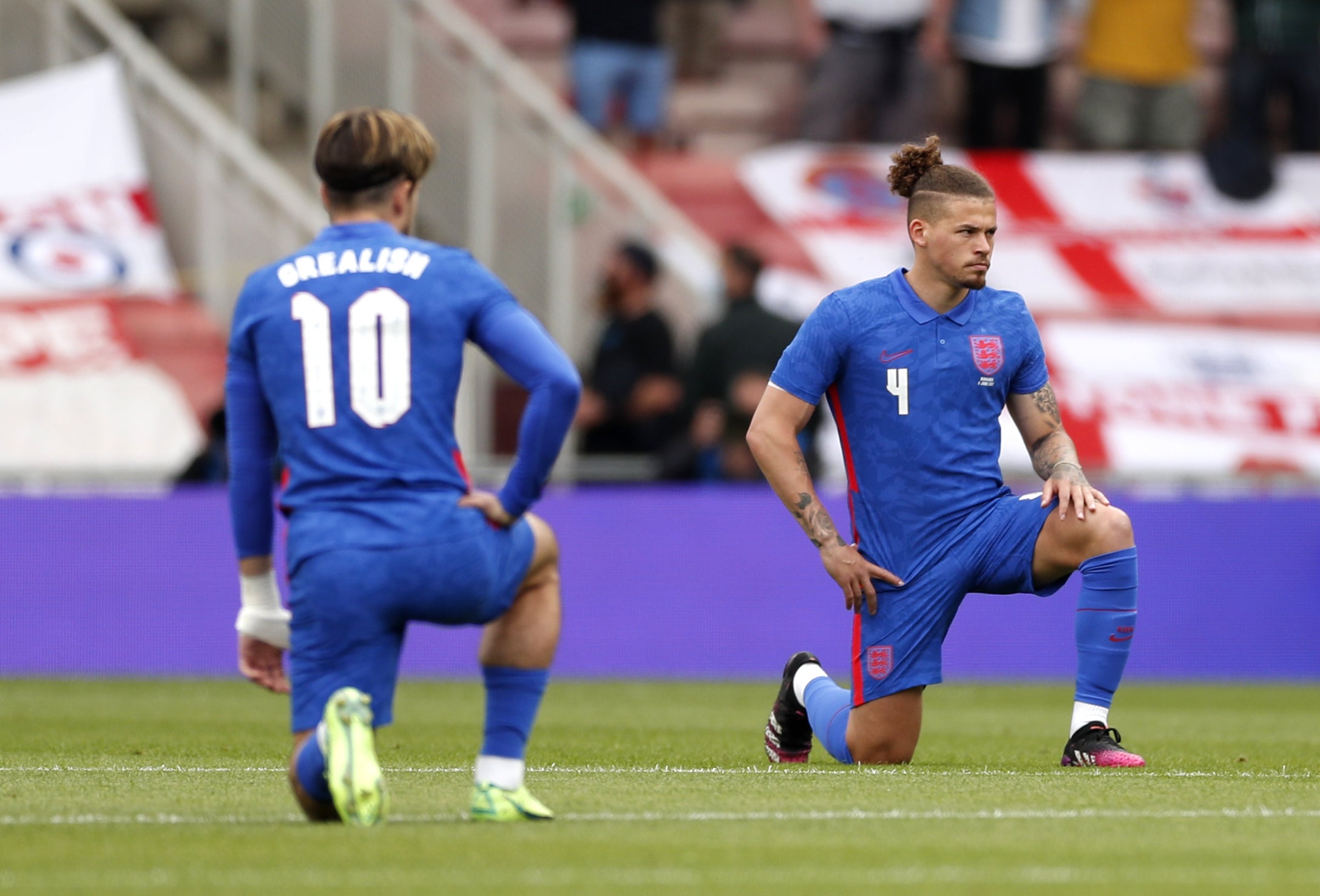 Jack Grealish and Kalvin Phillips take a knee before England's game with Romania