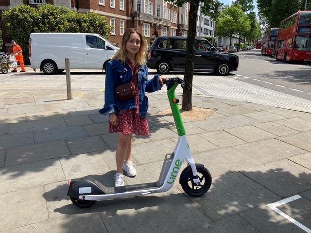 <p>Beata Onikul, 20, hires a rental e-scooter in South Kensington, London, on the first day of a 12-month government-backed trial</p>