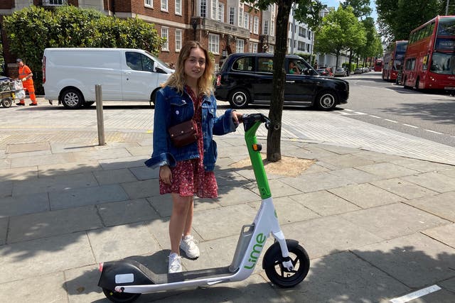 <p>Beata Onikul, 20, hires a rental e-scooter in South Kensington, London, on the first day of a 12-month government-backed trial</p>