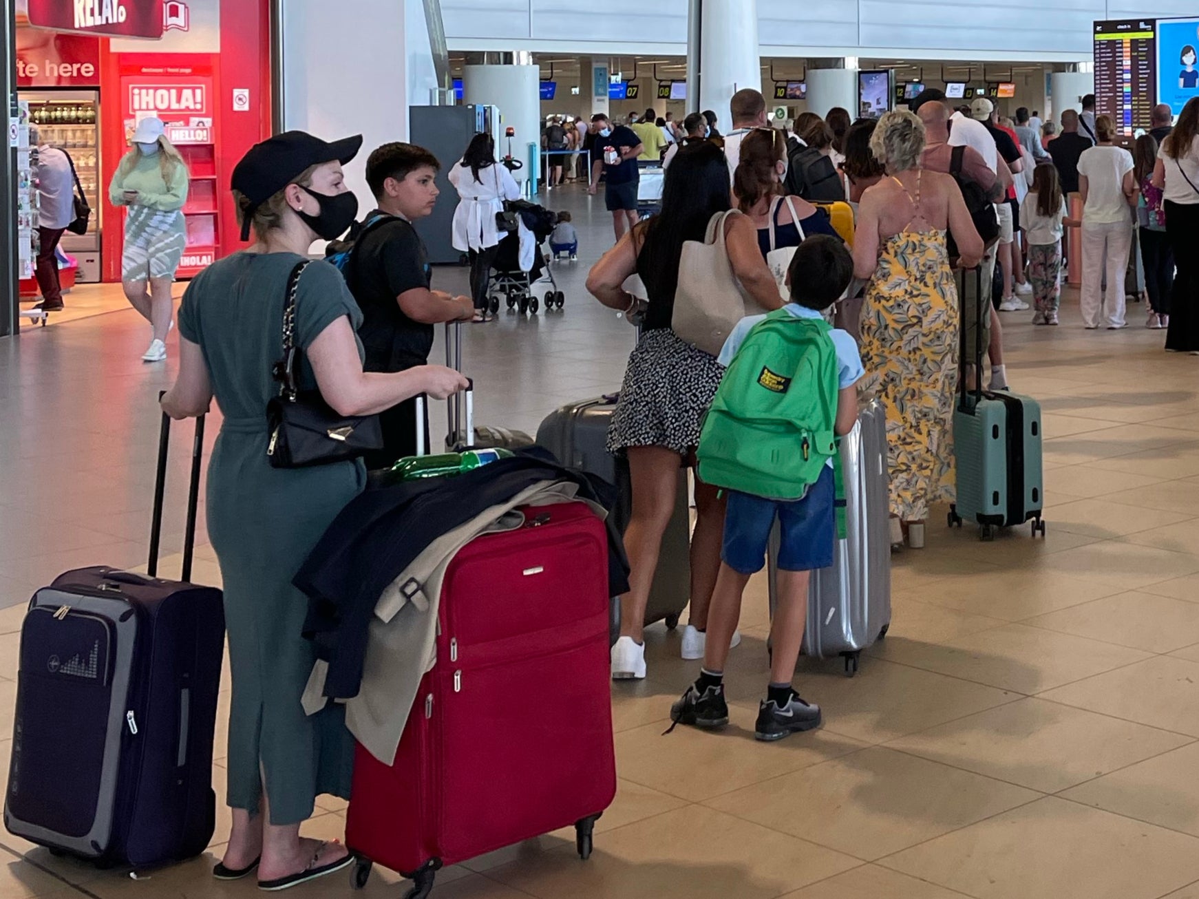 Homeward bound: passengers on flights to the UK queuing at Faro airport on Sunday evening