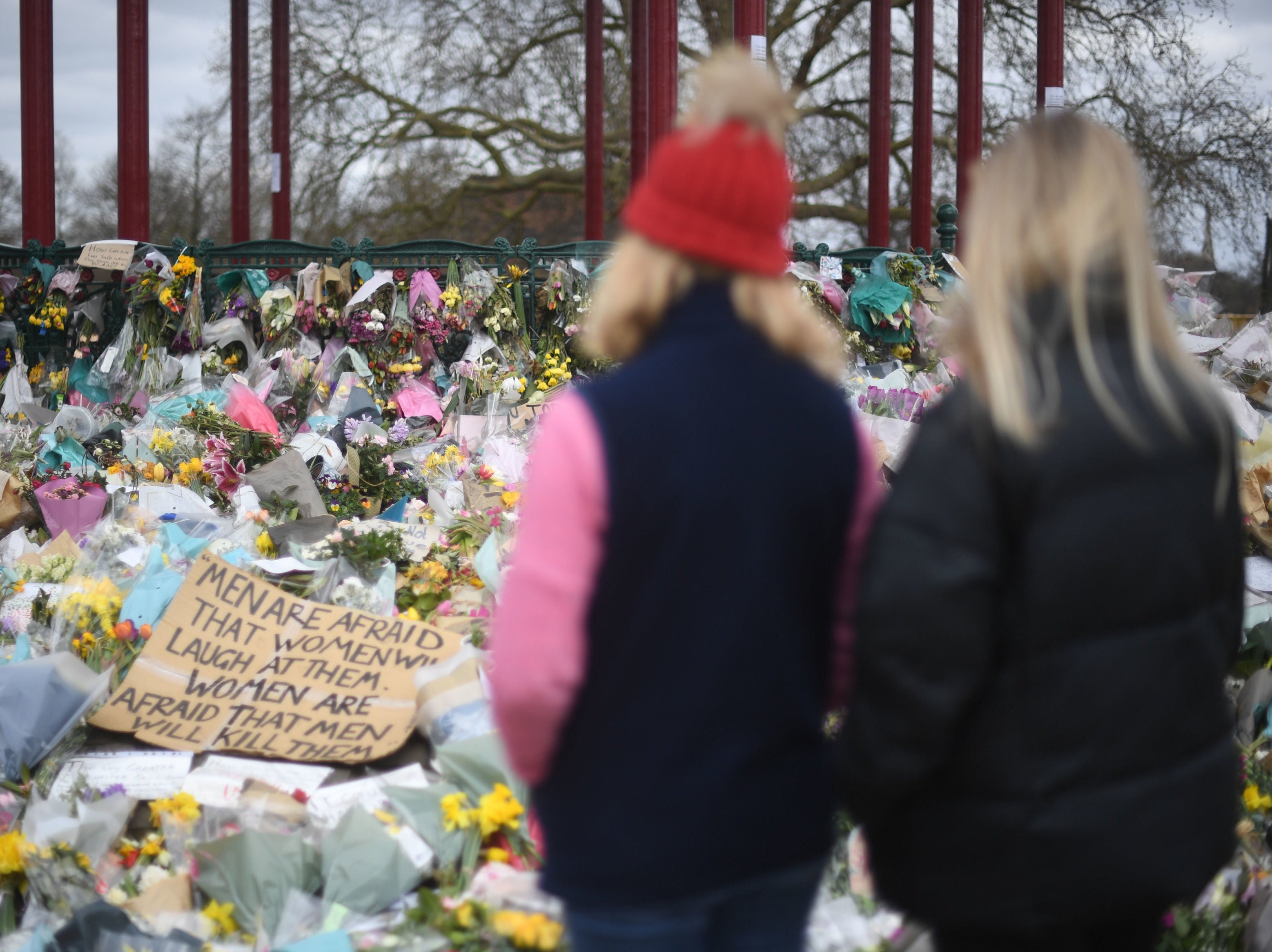 People view floral tributes left at the bandstand in Clapham Common, London, for Sarah Everard