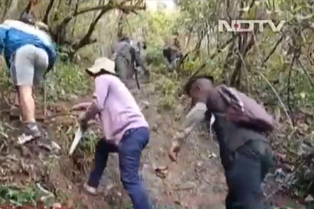 <p>Students in a remote village in Mizoram trekking up the hill in search of internet to take their online semester exams</p>