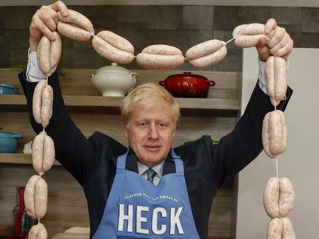 <p>Porkies: Johnson holding aloft a string of ‘Boris bangers’ during his party leadership bid in 2019</p>