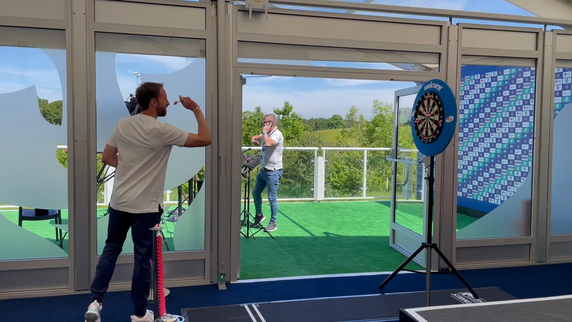 Gareth Southgate plays darts at the England media centre