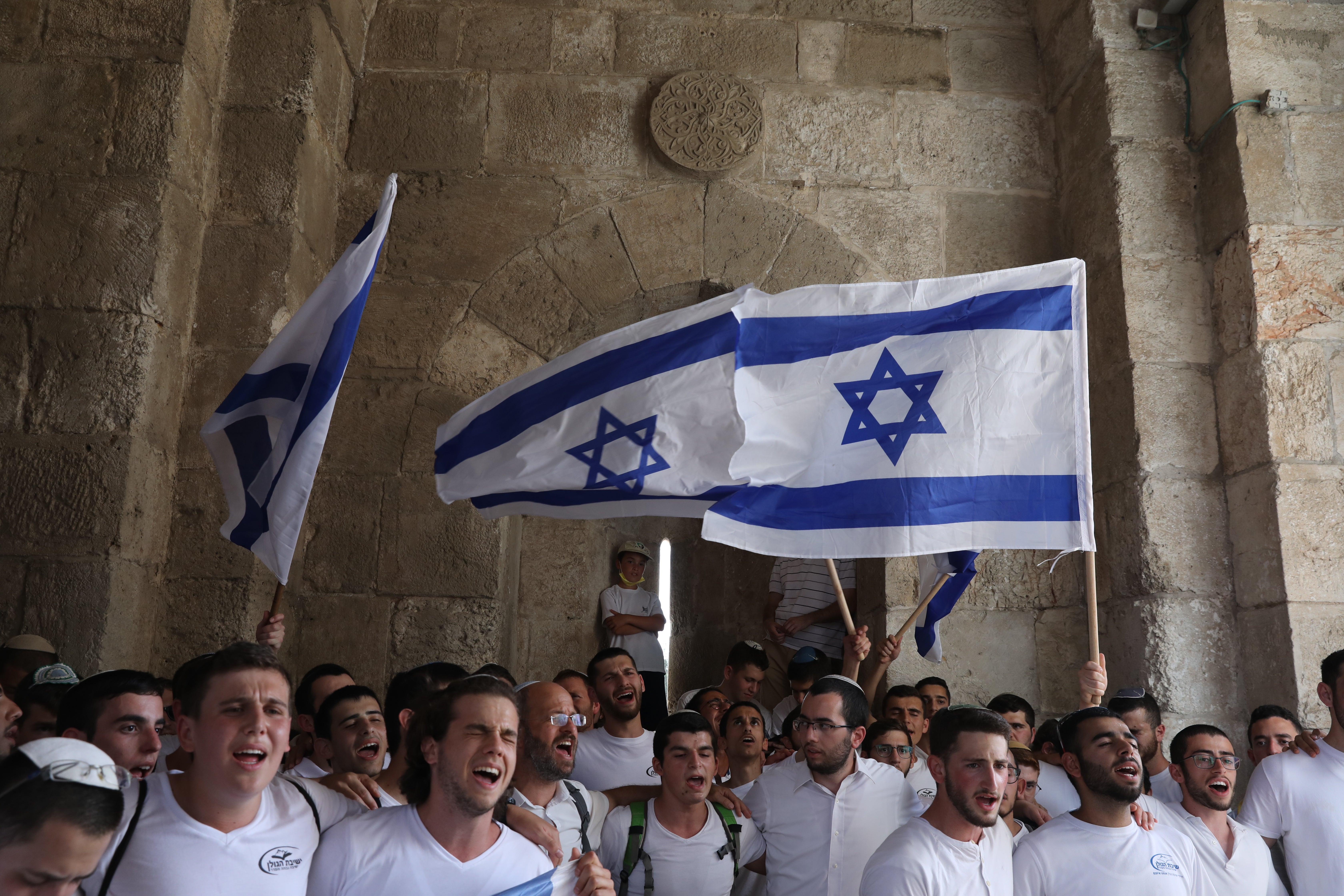 Israelis march with national flags celebrating the Jerusalem liberation day at the Jaffa gate in the old city of Jerusalem, 10 May 2021.