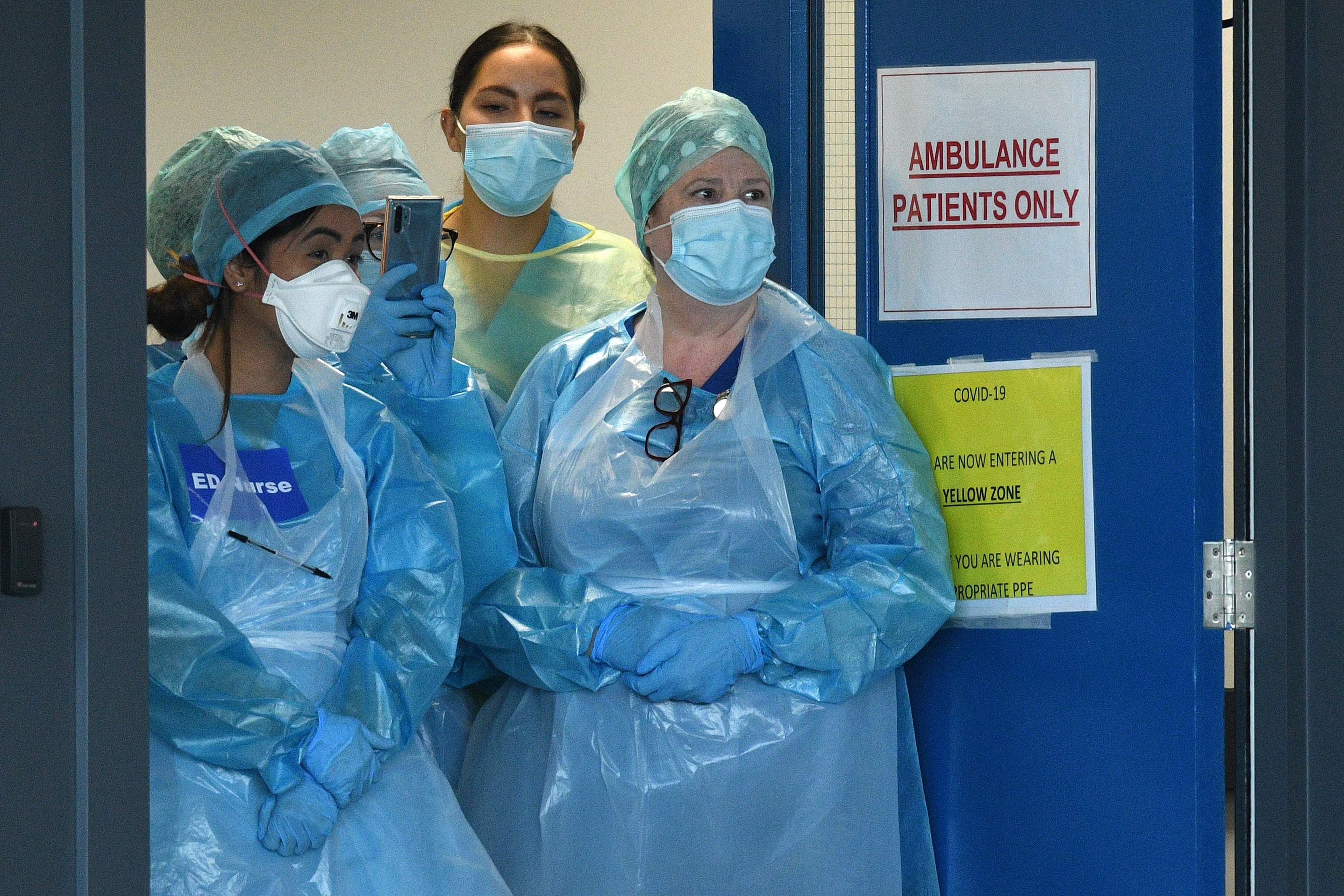 NHS workers wearing PPE (personal protective equipment), including a face mask, gloves and aprons