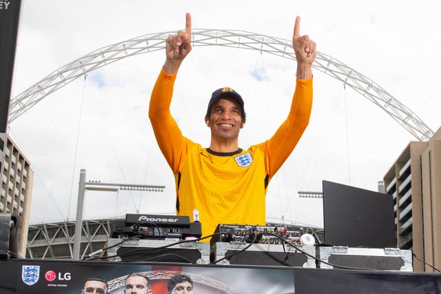 <p>Former England goalkeeper David James points to the sky under the Wembley arch</p>