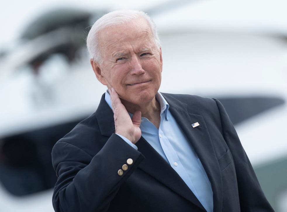 <p>US President Joe Biden wipes his neck after a cicada landed on him while boarding Air Force One at Andrews Air Force Base</p>
