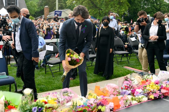 <p>Canada’s Prime Minister Justin Trudeau places flowers at a vigil for the victims of the deadly vehicle attack on five members of the Canadian Muslim community in London, Ontario, on Tuesday, June 8, 2021.</p>