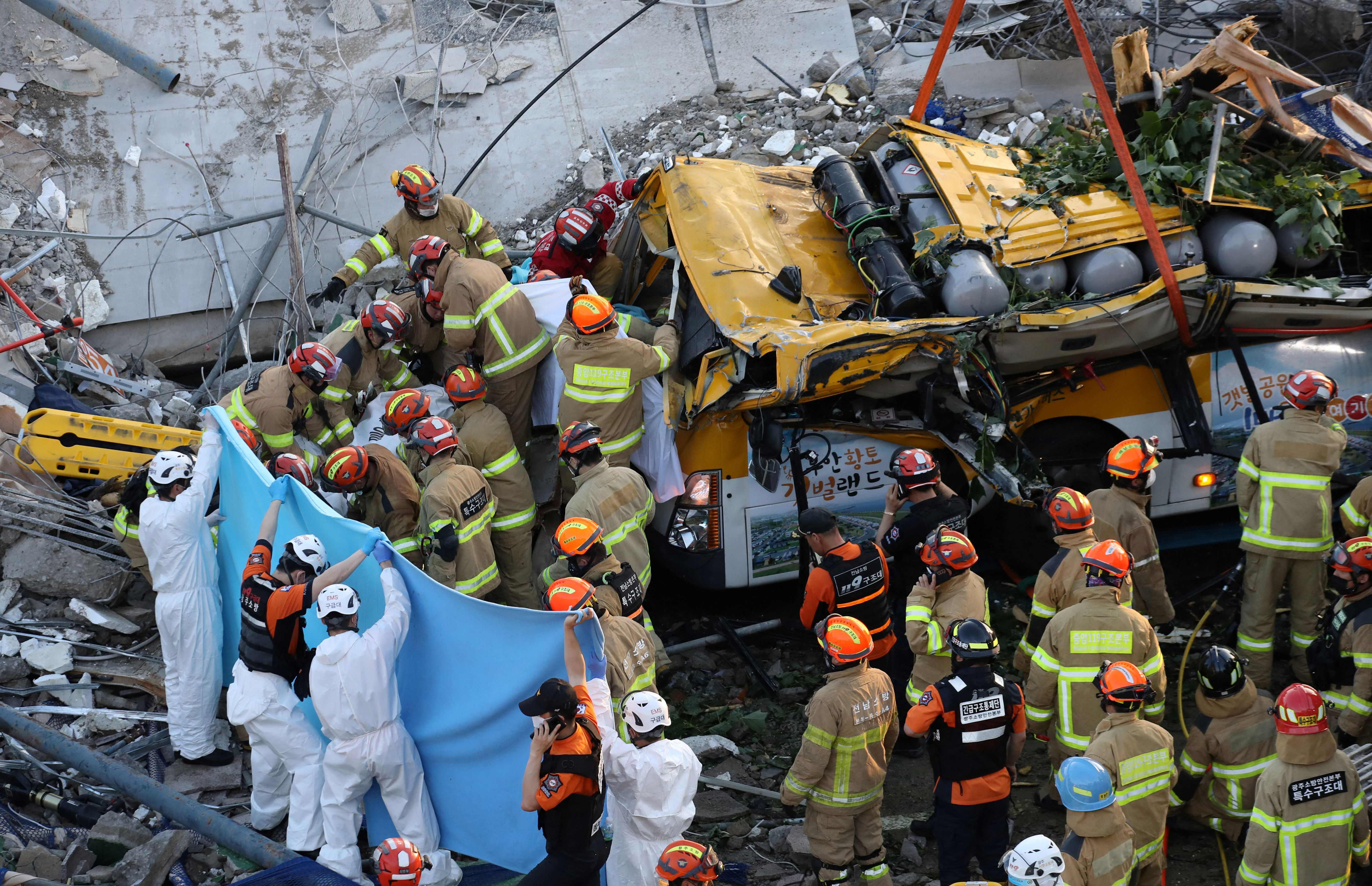 South Korean rescue workers search for possible survivors after a building collapsed in Gwangju on 9 June, 2021.