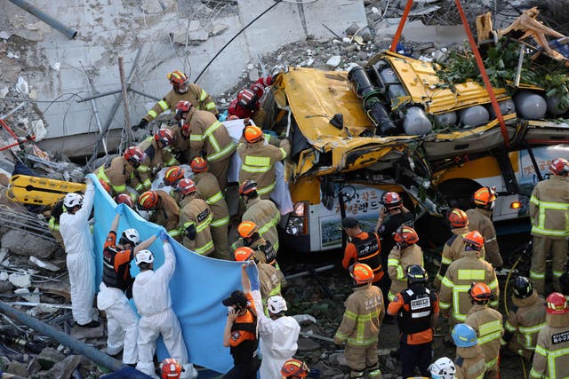 <p>South Korean rescue workers search for possible survivors after a building collapsed in Gwangju on 9 June, 2021.</p>