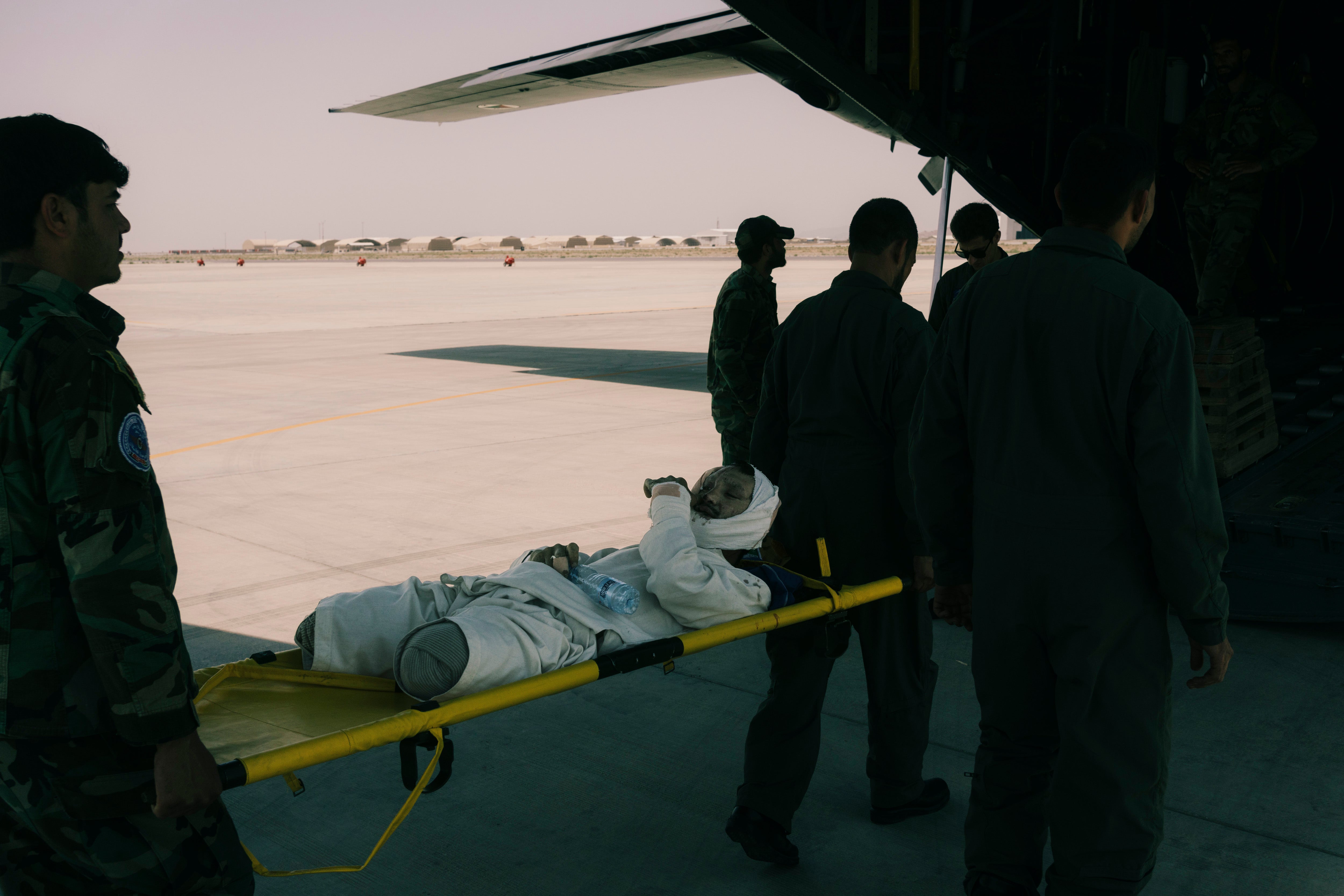 A member of the Afghan security forces is evacuated on a military flight from Kandahar airfield to Kabul