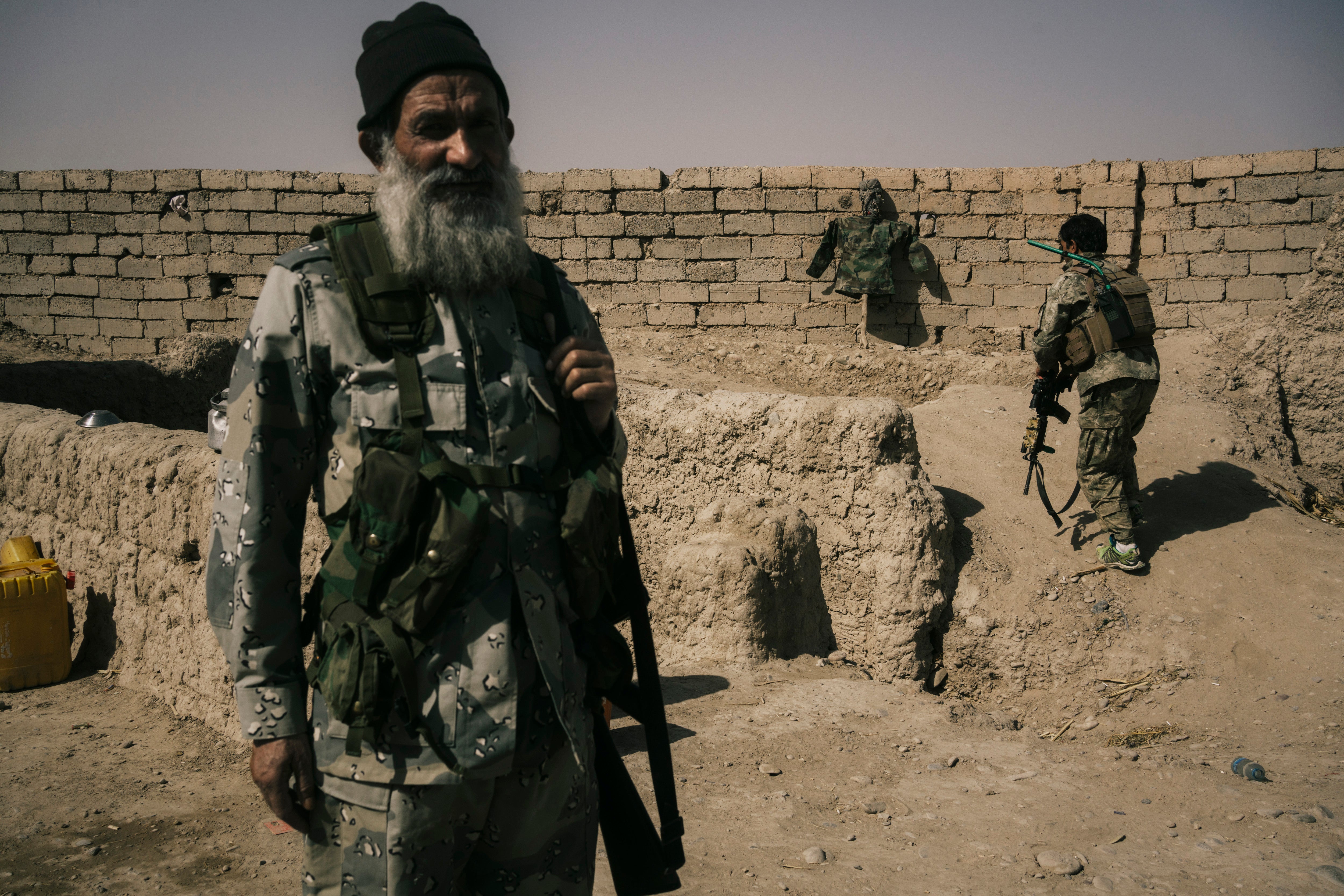 Afghan army soldiers exposed to Taliban fire on the Nazar front line outpost near Lashkar Gah