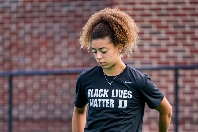 England Under-21 hockey player Darcy Bourne takes the knee wearing a Black Lives Matter T-shirt