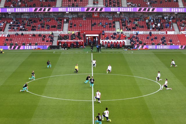 <p>England and Austria players kneel ahead of a friendly this month</p>