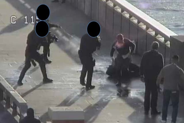 <p>A still from CCTV footage showing armed police officers confronting Usman Khan after he was subdued by members of the public</p>