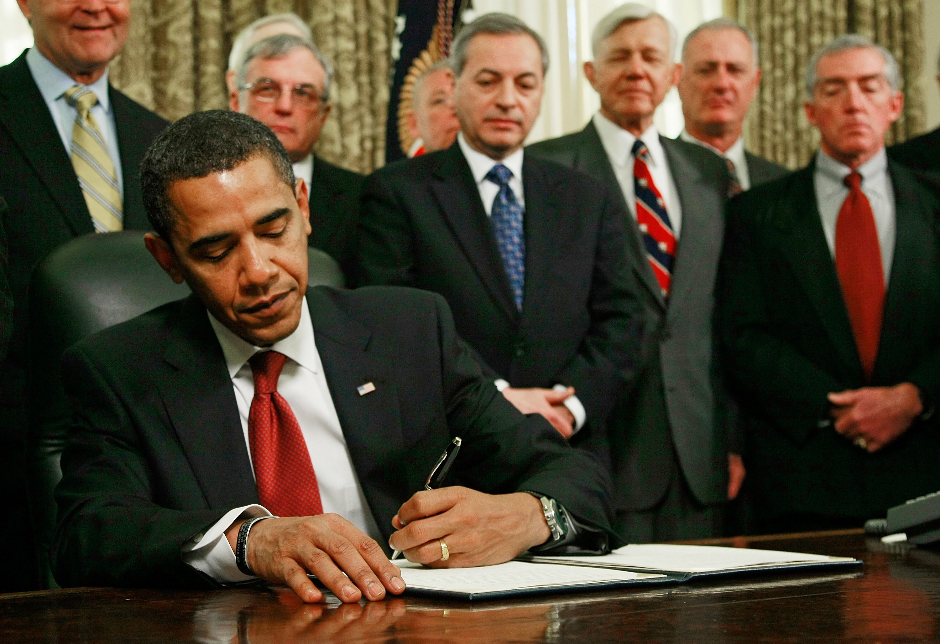 Barack Obama signs – with his left hand – an executive order to close down the detention centre at Guantanamo Bay in Cuba