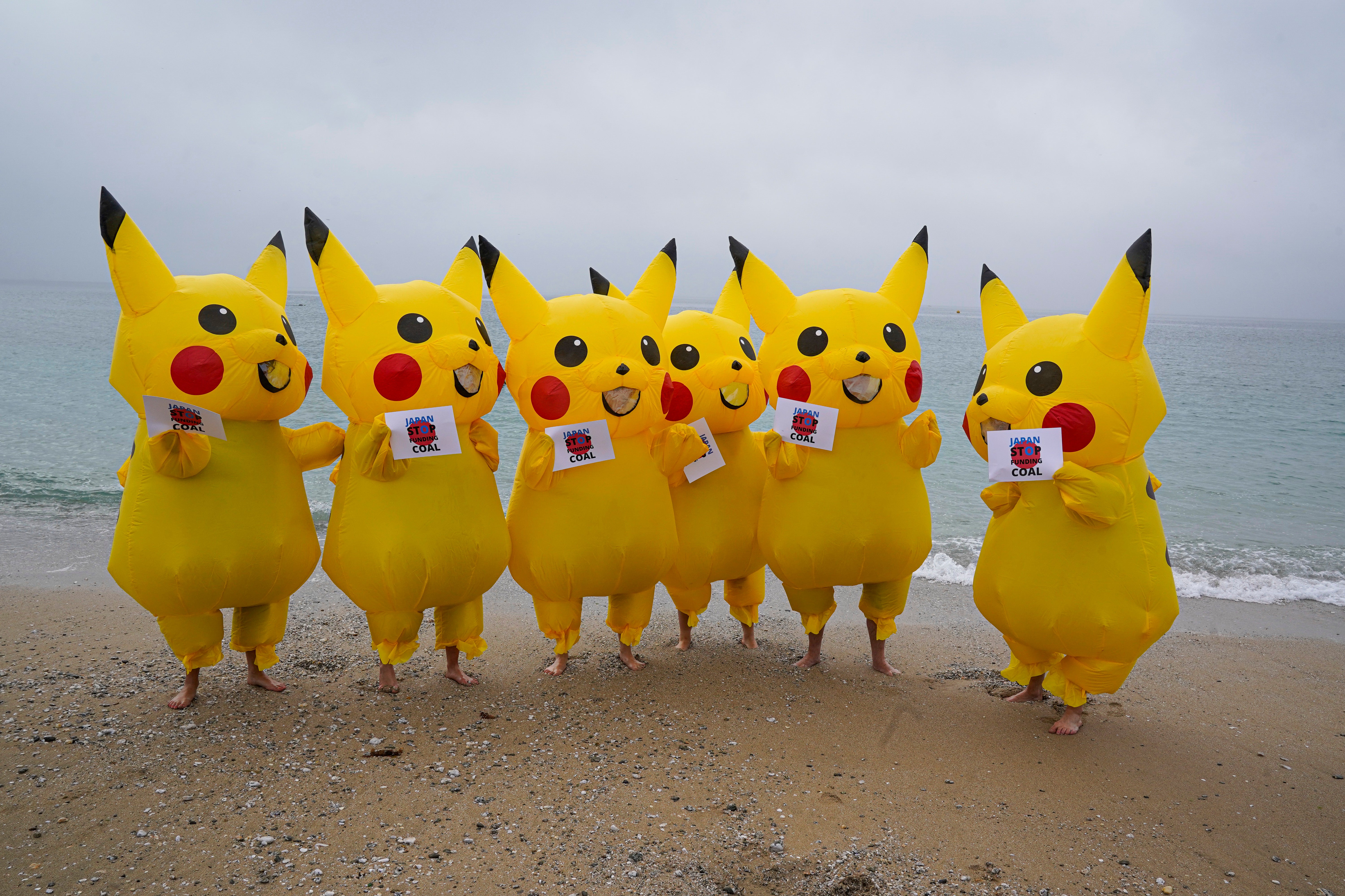 Protesters dressed as Pikachus object to Japan’s coal policy on a beach in Cornwall