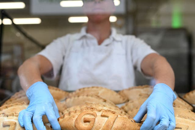 <p>Freshly baked G7 Cornish pasties are placed in the window of a pastry shop in St Ives, Cornwall </p>