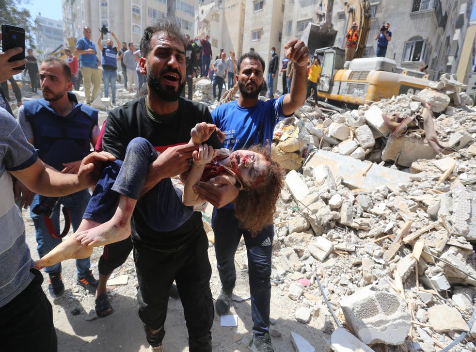 <p>Susie, 7, is pulled from the rubble after the 16 May bombardment</p>