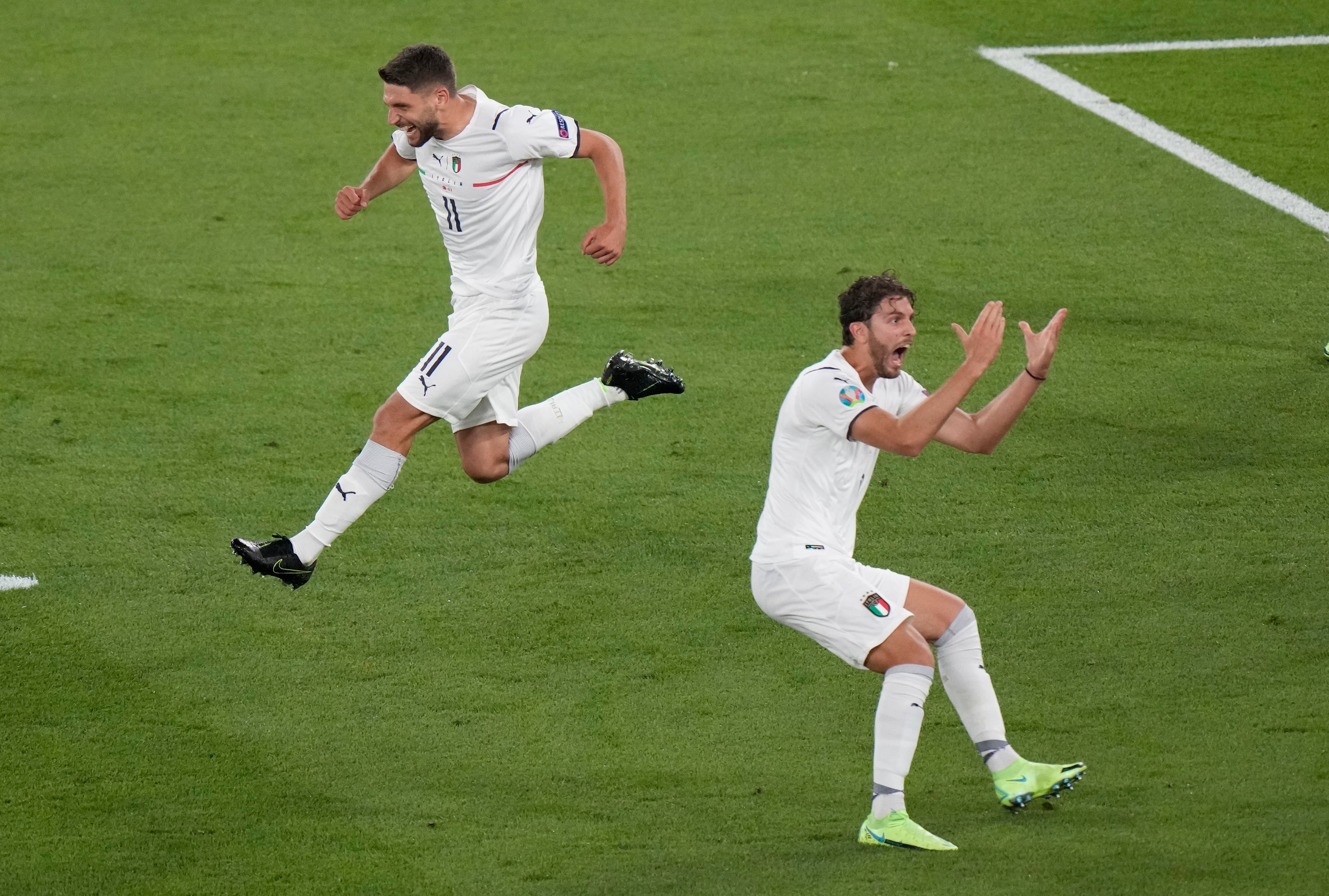 Italy’s Domenico Berardi, left, and Manuel Locatelli celebrate after Turkey’s Merih Demiral diverted the ball into his own net for the opening goal of Euro 2020