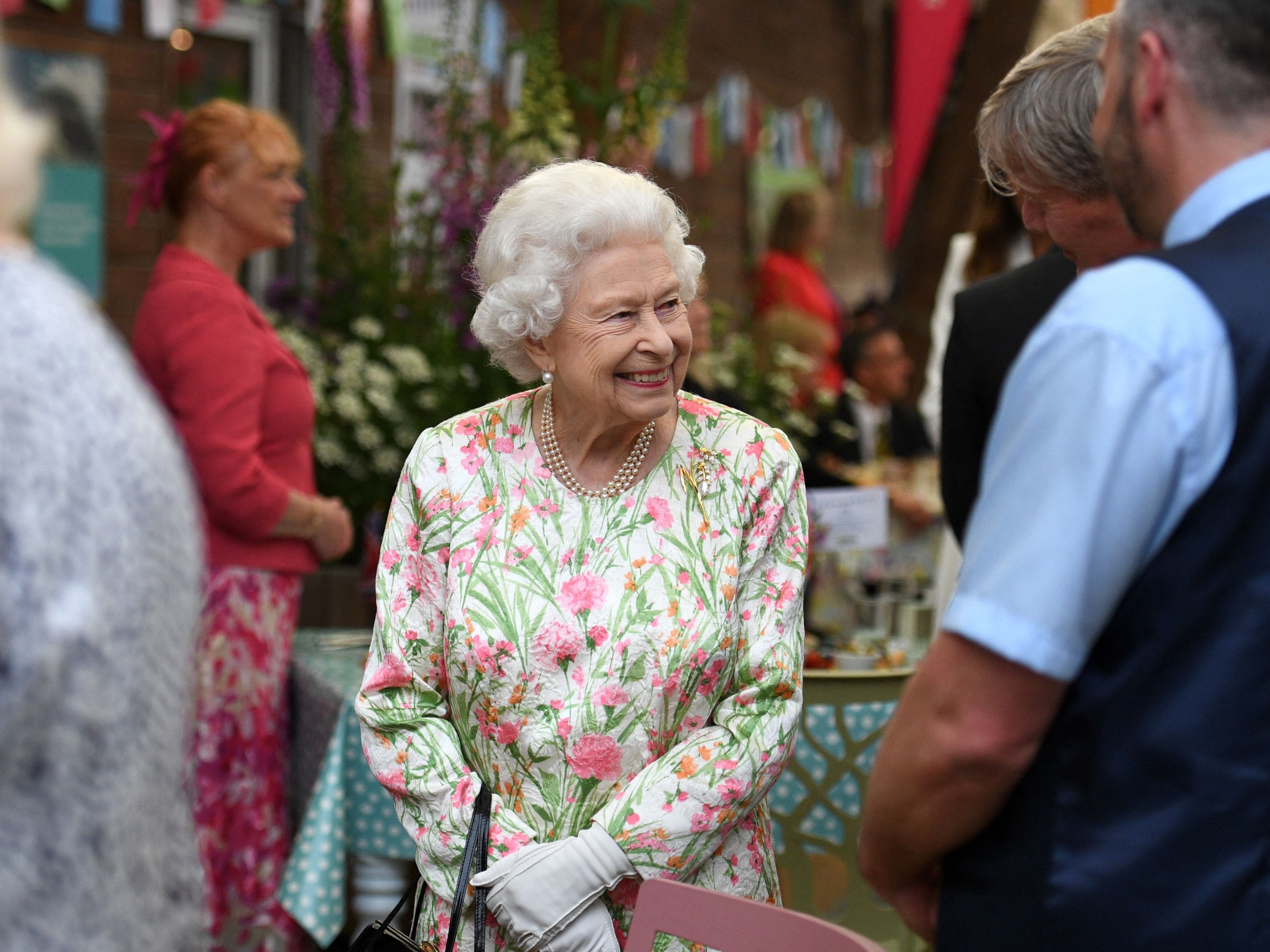 Queen Elizabeth II smiles as she meets people from communities across Cornwall