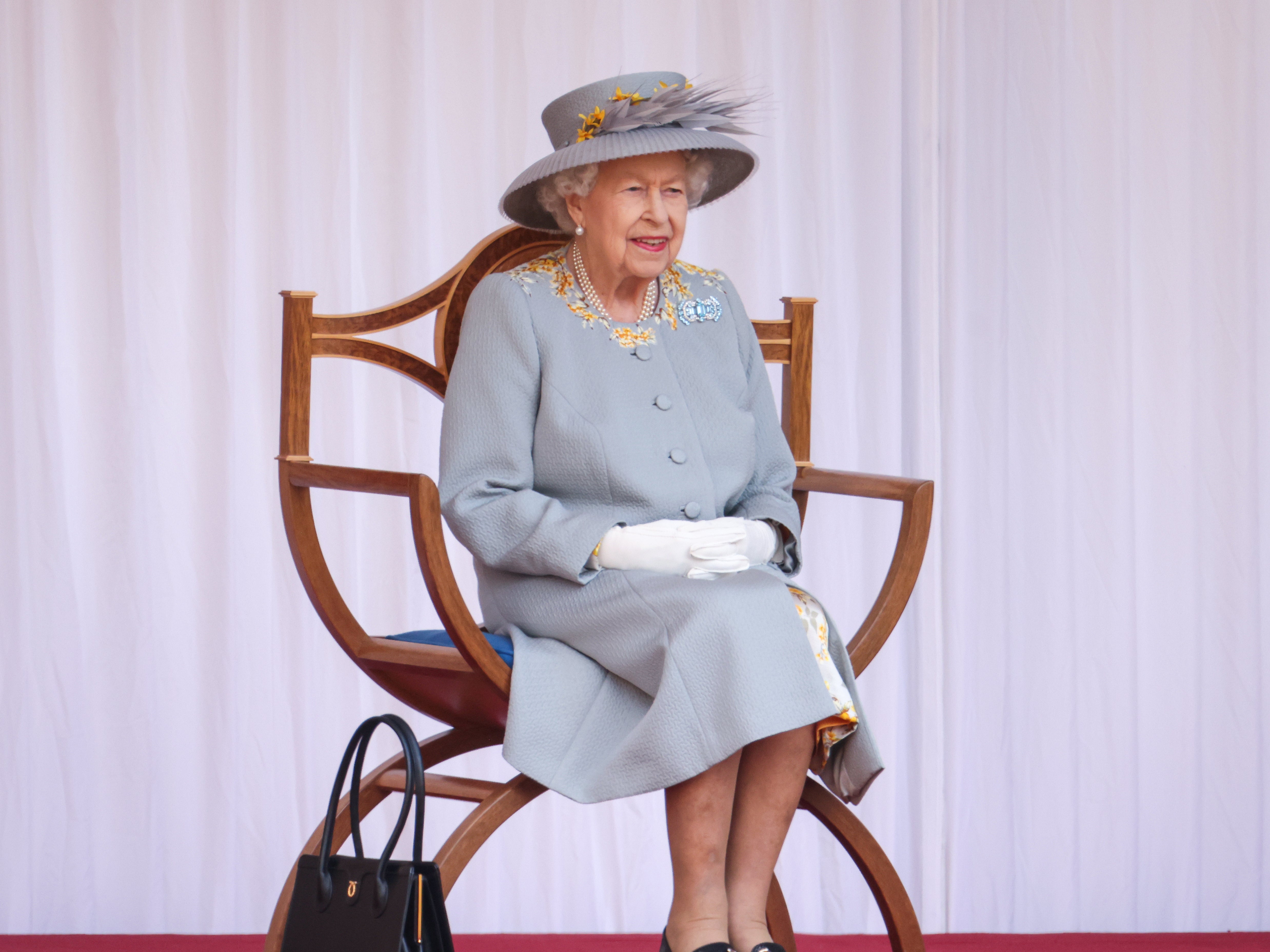 The Queen smiles as she watches the fly past