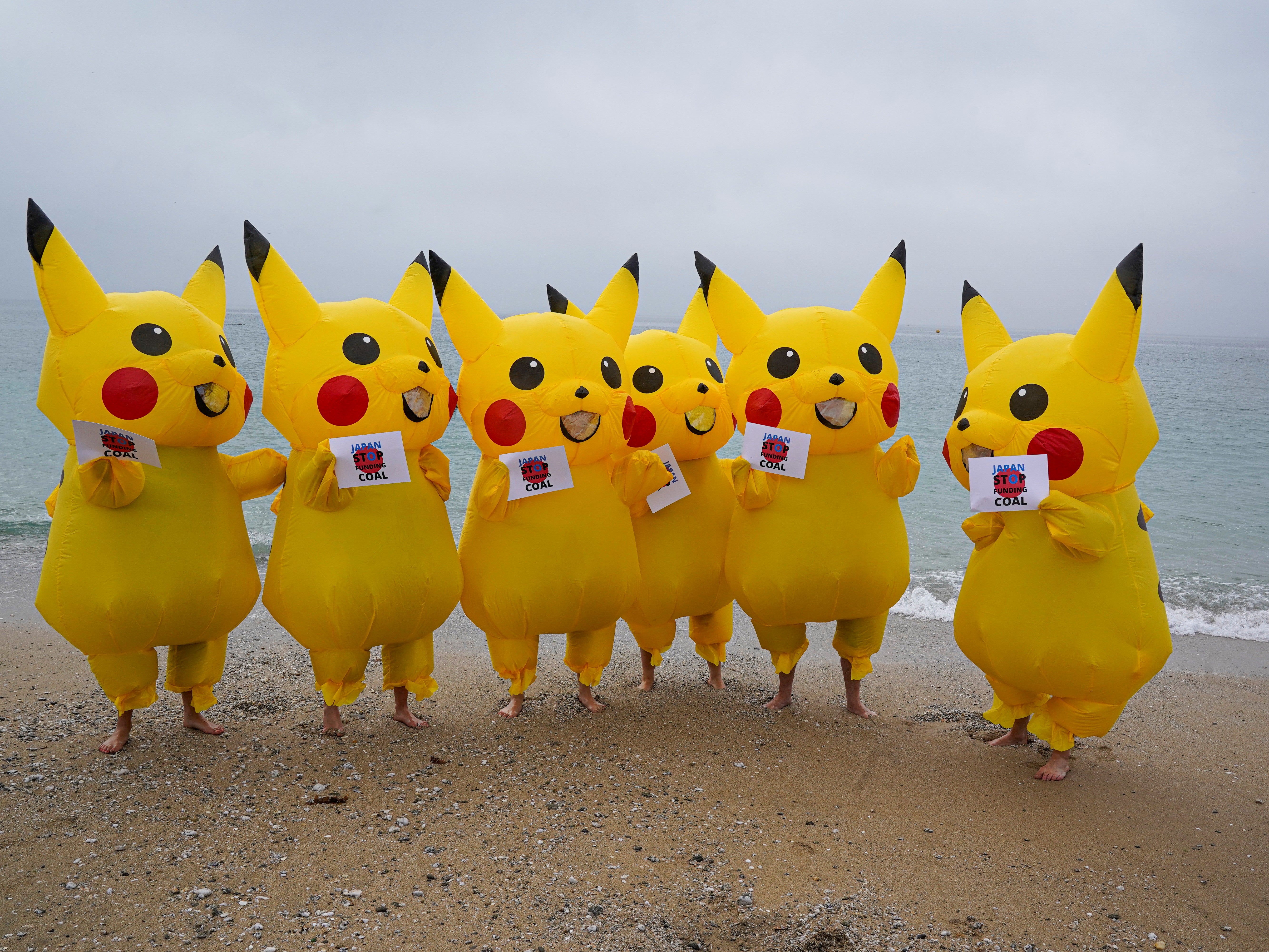 Protesters dressed as Pikachu characters demonstrate on Gyllyngvase Beach, Falmouth