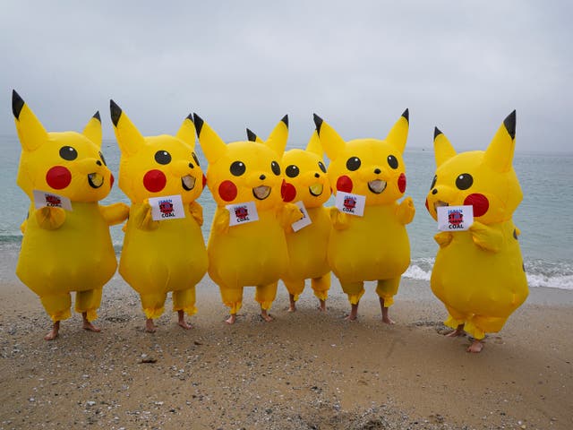 <p>Protesters dressed as Pikachu characters demonstrate on Gyllyngvase Beach, Falmouth</p>