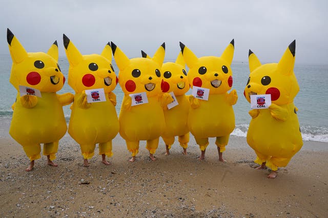 <p>Protesters dressed as Pikachu characters demonstrate on Gyllyngvase Beach, Falmouth</p>