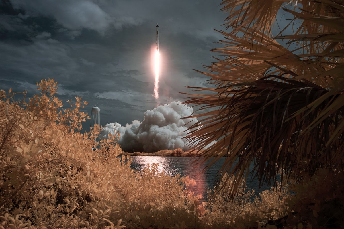 In this NASA handout image, A SpaceX Falcon 9 rocket carrying the company's Crew Dragon spacecraft is seen in this false color infrared exposure as it is launched on NASAs SpaceX Demo-2 mission to the International Space Station with NASA astronauts Robert Behnken and Douglas Hurley onboard, Saturday, May 30, 2020, at NASAs Kennedy Space Center in Florida.