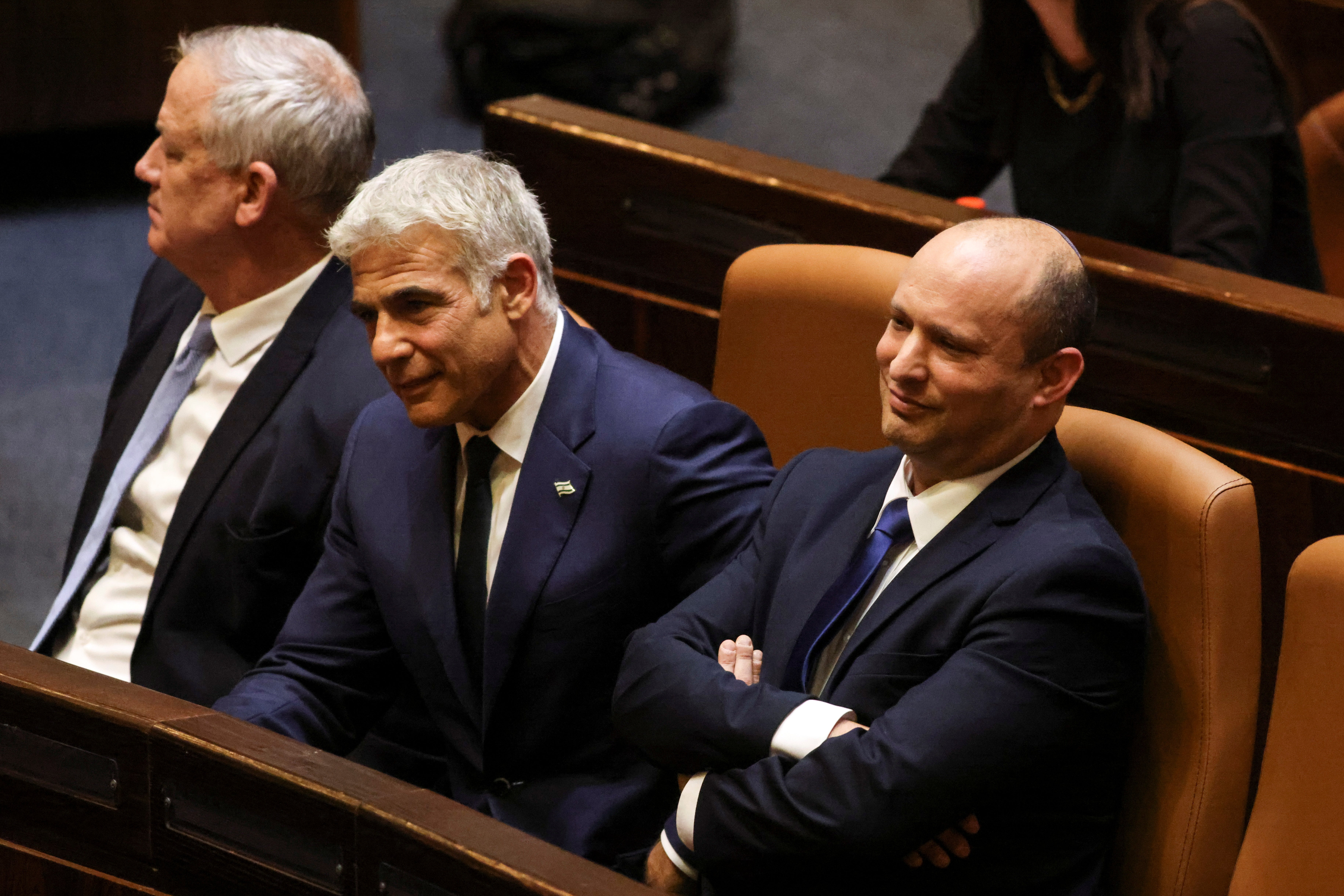 Israeli defence minister Benny Gantz, foreign minister Yair Lapid and new PM Naftali Bennett sit side by side (left to right) in parliament on Sunday