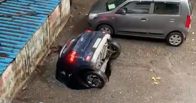 <p>Screengrab from a video of a car falling into a well in a residential complex in Mumbai, India</p>