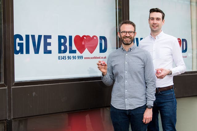 <p>Married couple Steven Smillie and Tyler McNeil mark the changes to blood donation rules at Edinburgh Donor Centre in Scotland</p>