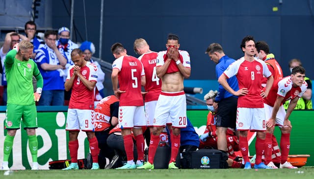 <p>Denmark's players are visibly shaken after Christian Eriksen's collapse during their Euro 2020 game against Finland</p>