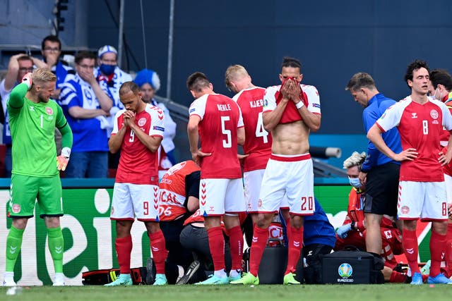 <p>Denmark's players are visibly shaken after Christian Eriksen's collapse during their Euro 2020 game against Finland</p>