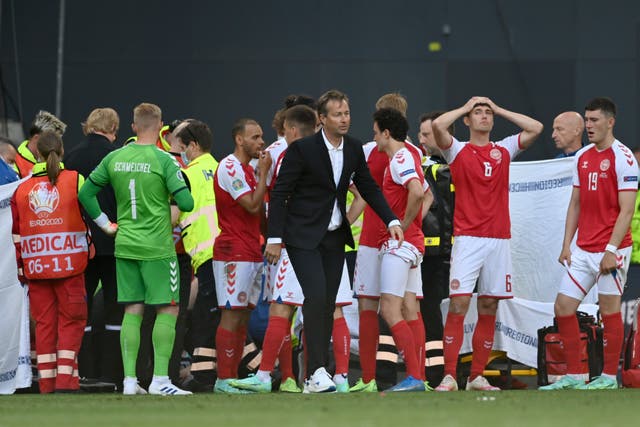 <p>Denmark’s players look on anxiously as teammate Eriksen receives life-saving treatment during Saturday’s Euro 2020 match against Finland</p>