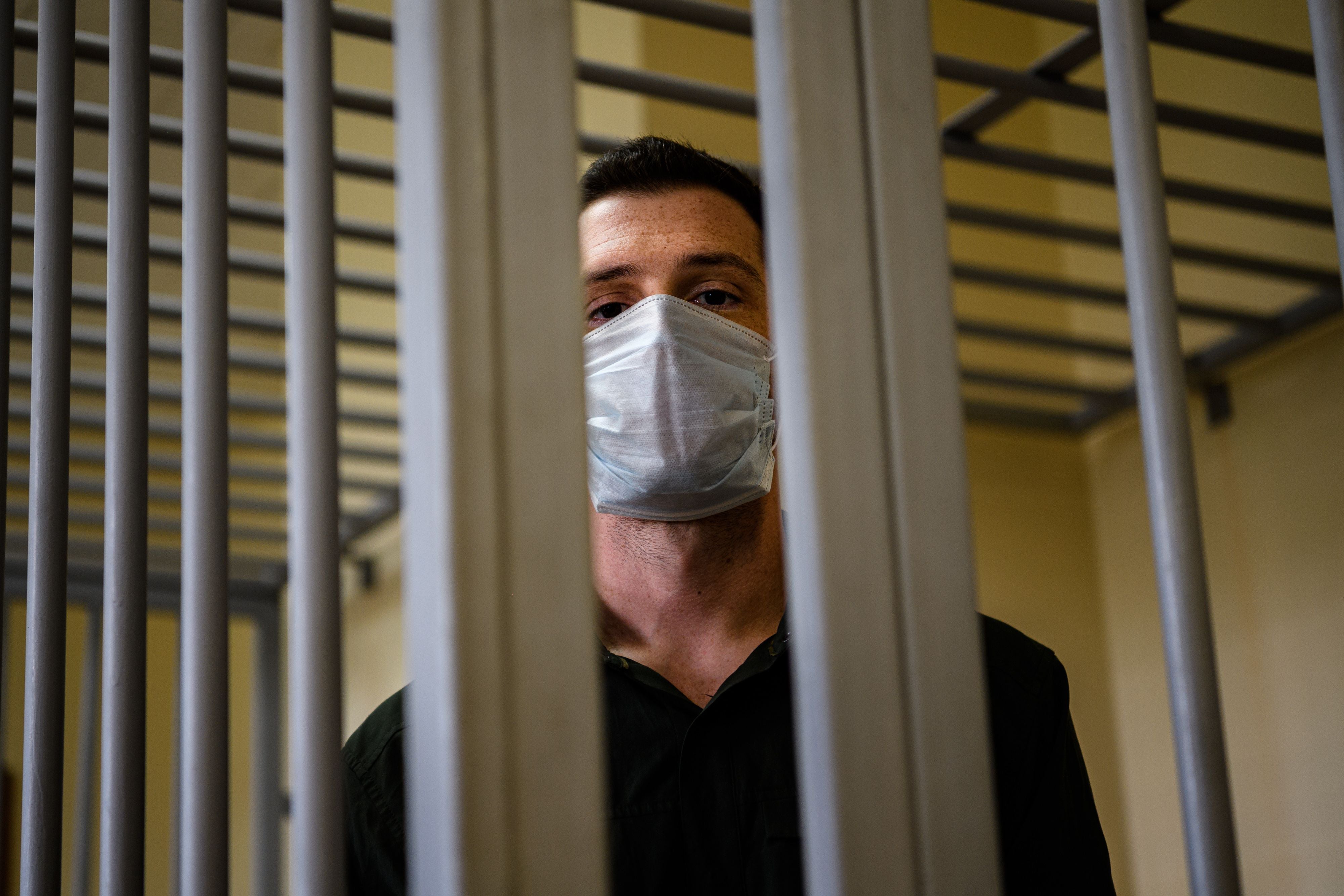 US ex-marine Trevor Reed, then charged with attacking police, stands inside a defendants’ cage during his verdict hearing at Moscow’s Golovinsky district court on 30 July, 2020.