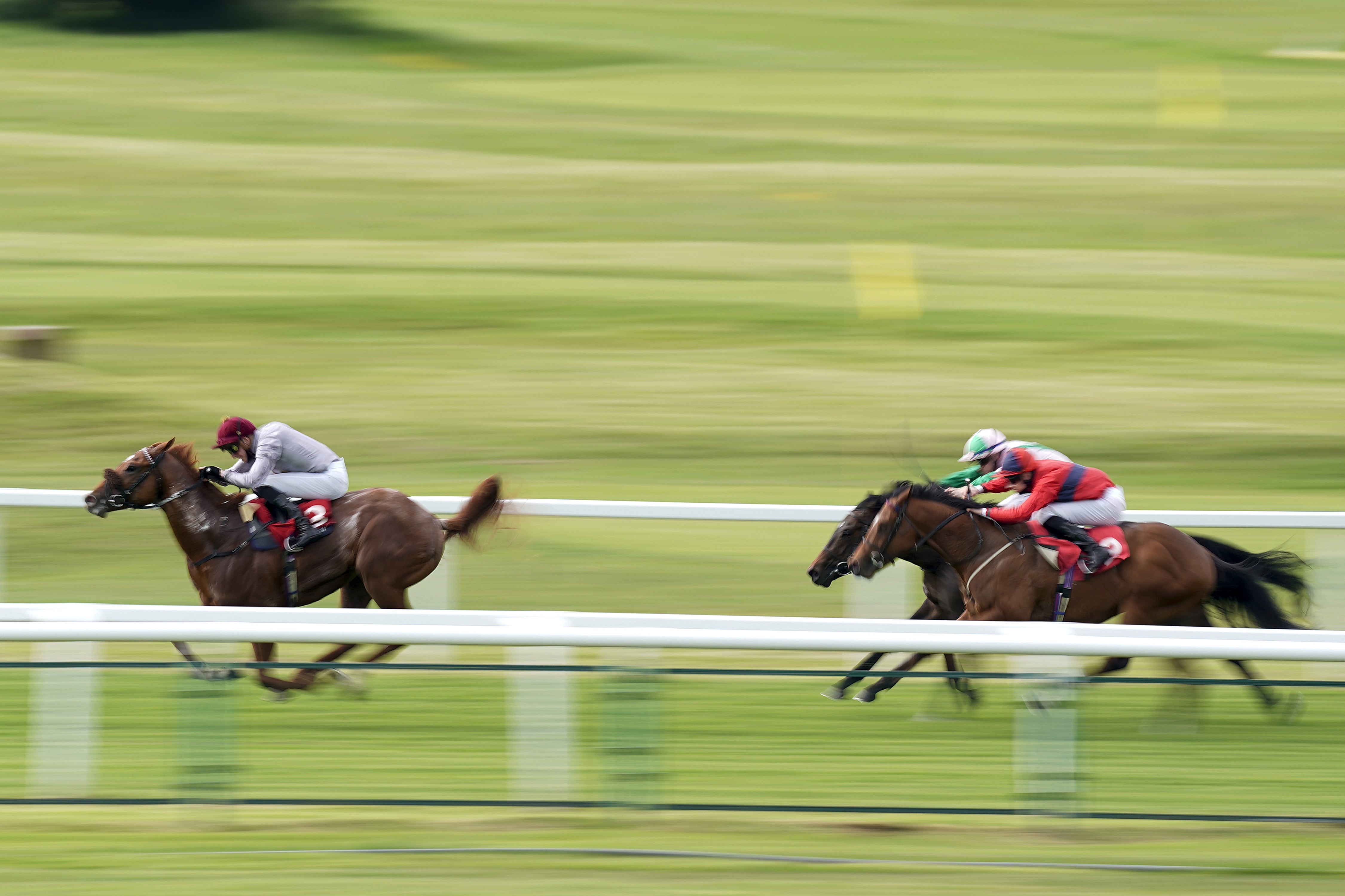 James Doyle riding Ebro River (left) coming home to win The Coral ‘Beaten By A Length’ National Stakes at Sandown Park Racecourse