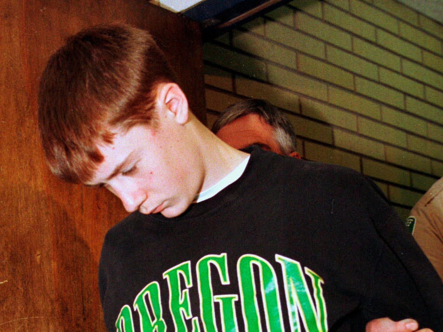 In this May 22, 1998, file photo, Thurston High School student Kip Kinkel, 15, is led to his arraignment in Eugene, Ore.
