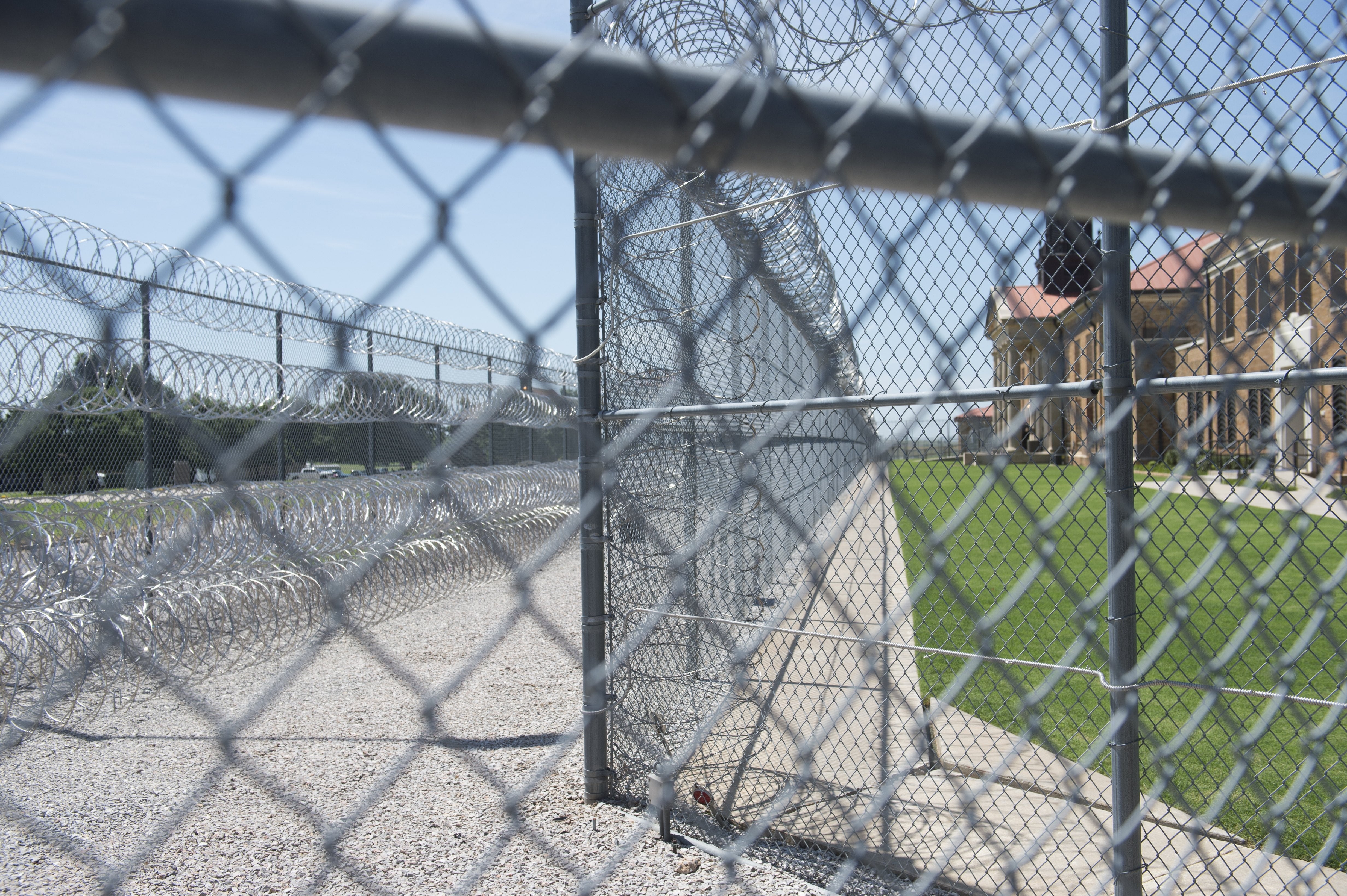 Fences and barbed wire at the entrance of the El Reno Federal Correctional Institution in El Reno, Oklahoma, 16 July, 2015.
