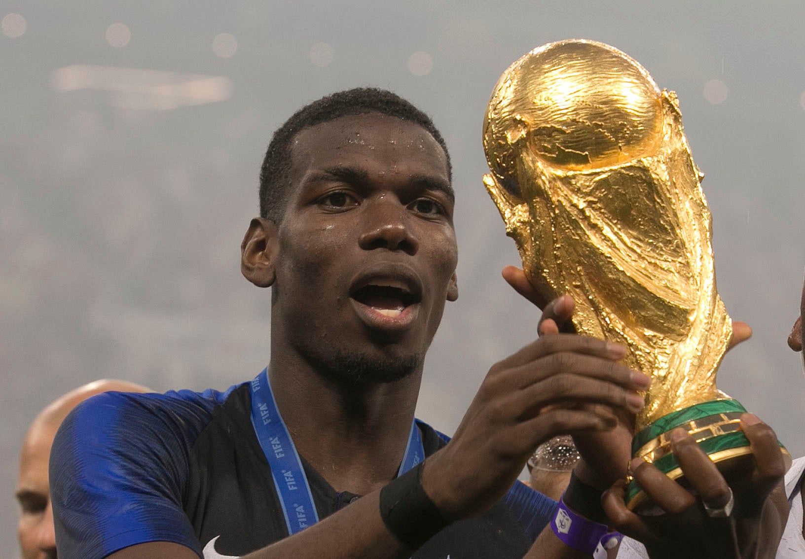 Paul Pogba celebrates with the World Cup trophy