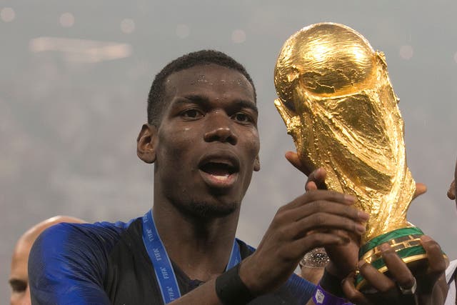 Paul Pogba celebrates with the World Cup trophy