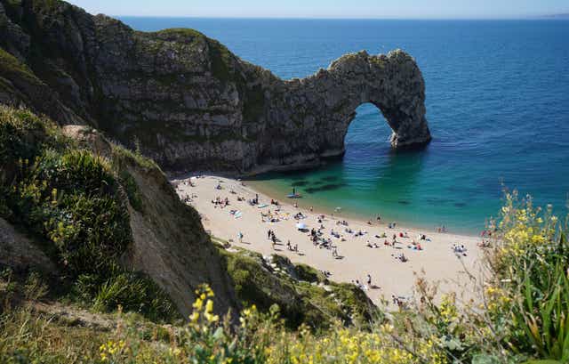 <p>Dorset Police said the woman, who has not been identified, was pronounced dead at the scene (pictured: Durdle Door in early June)</p>