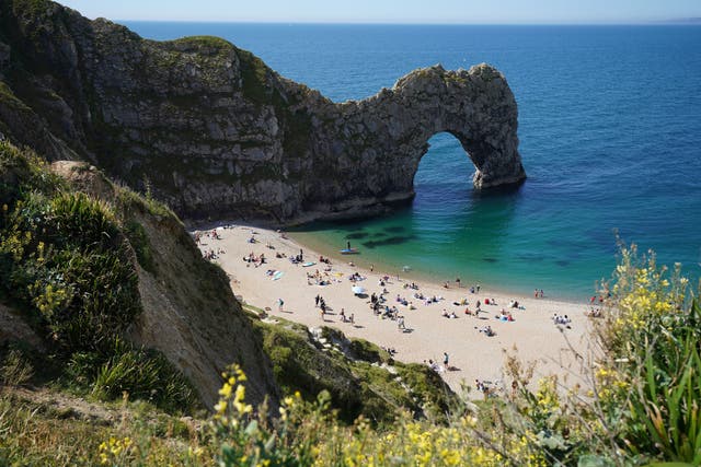 <p>Dorset Police said the woman, who has not been identified, was pronounced dead at the scene (pictured: Durdle Door in early June)</p>
