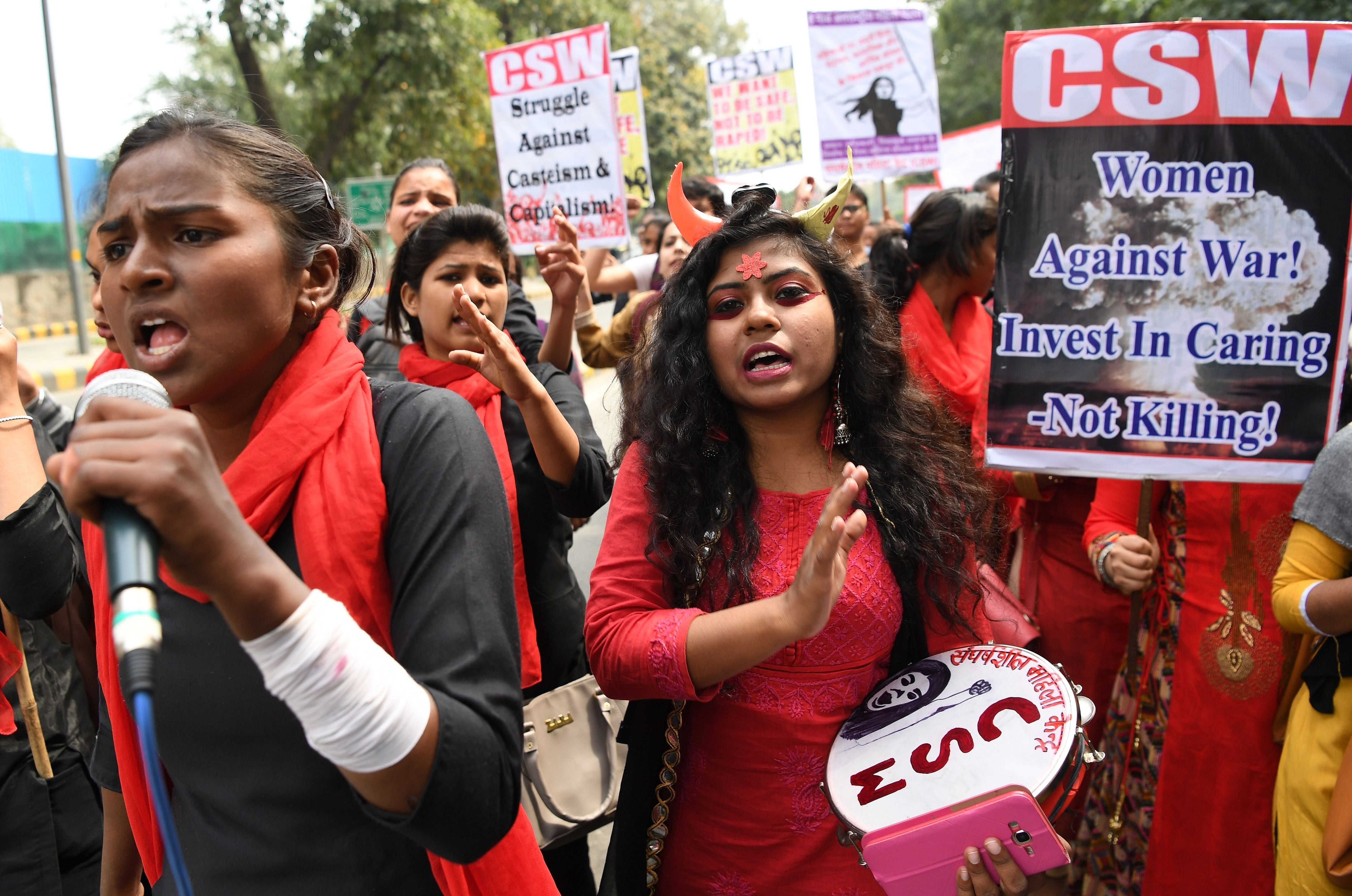 Indian women shout slogans at a march to mark International Women’s Day in New Delhi on March 8, 2019. A women from a scheduled tribe in India was beaten, stripped and paraded naked through the village for ‘having an extra-marital affair’