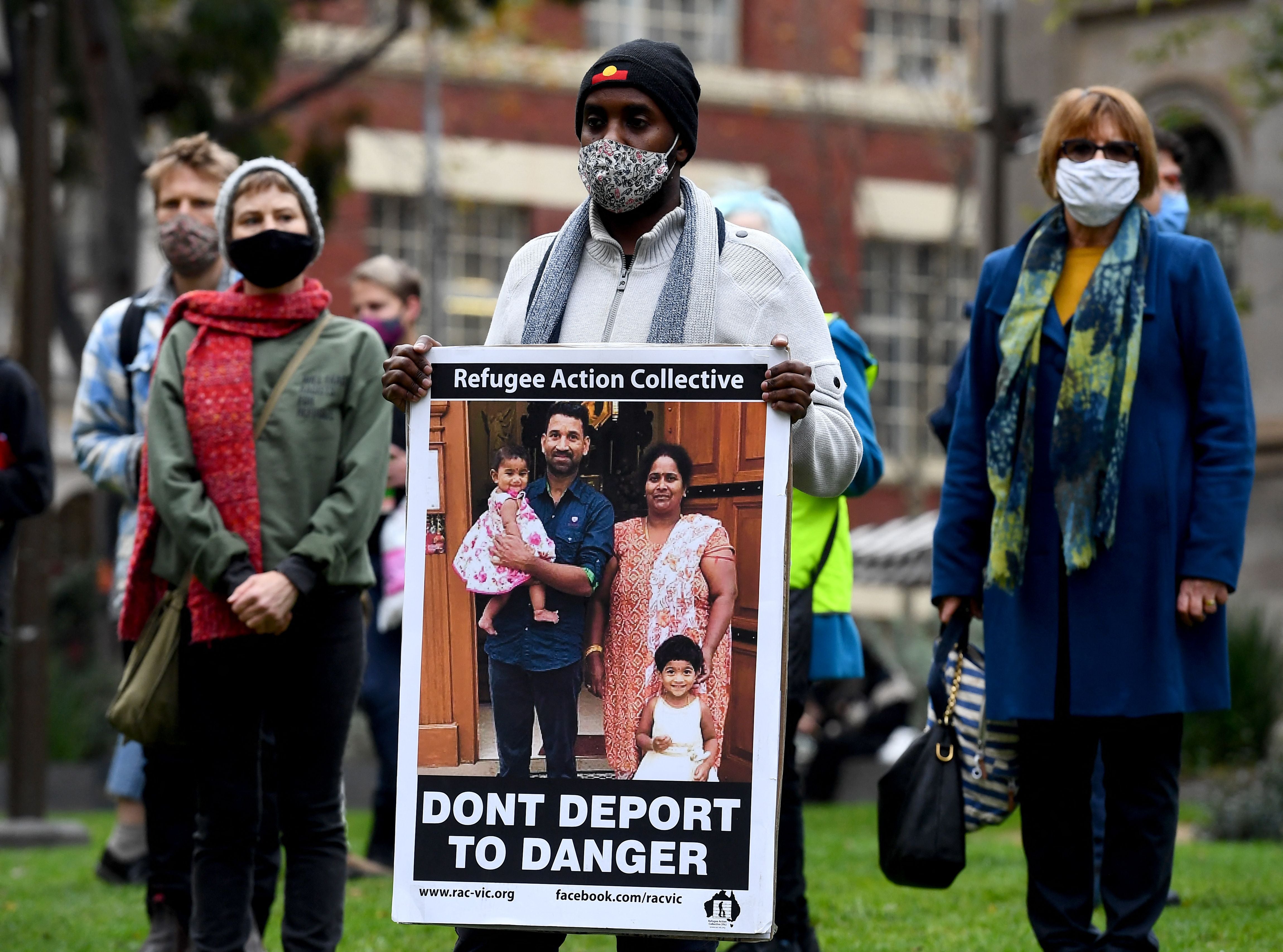 <p>People hold up placards at a rally to support the Sir Lankan origin Tamil family living in detention </p>