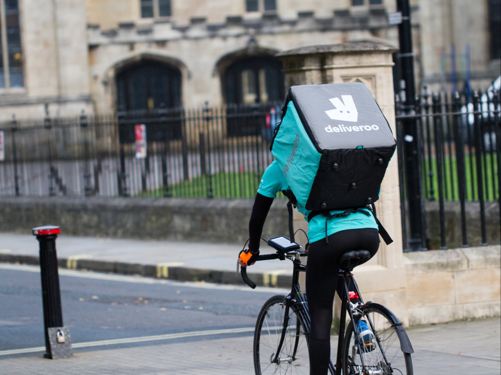 <p>A Deliveroo rider on a bicycle</p>