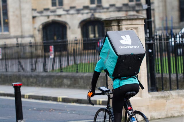 <p>A Deliveroo rider on a bicycle</p>
